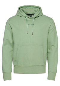 Ljusgrön hoodie av mjukt material. Har en framficka, dragsnören med metallspetsar och en diskret logotyp på bröstet.