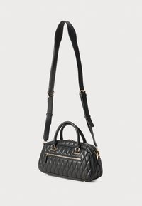 Black quilted handbag with a rounded shape, dual handles, a detachable shoulder strap, and gold-tone hardware, featuring a front zip pocket.