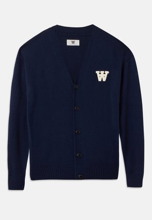 Navy cardigan made from soft knit fabric, featuring a V-neck, black buttons, ribbed cuffs, and a cream embroidered logo on the left chest.