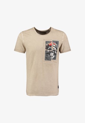 T-shirt in cotone beige con grafica frontale di un teschio con dettagli floreali in un motivo a toppa. Maniche corte e scollo a girocollo.