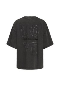 T-shirt noir oversize avec "LOVE" en clous à pois et "seExpression" brodé dans le dos. Aucune personne visible.