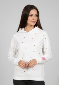 White hoodie with scattered pink heart patterns, kangaroo pocket, drawstring hood, and ribbed cuffs. Smooth fabric texture.