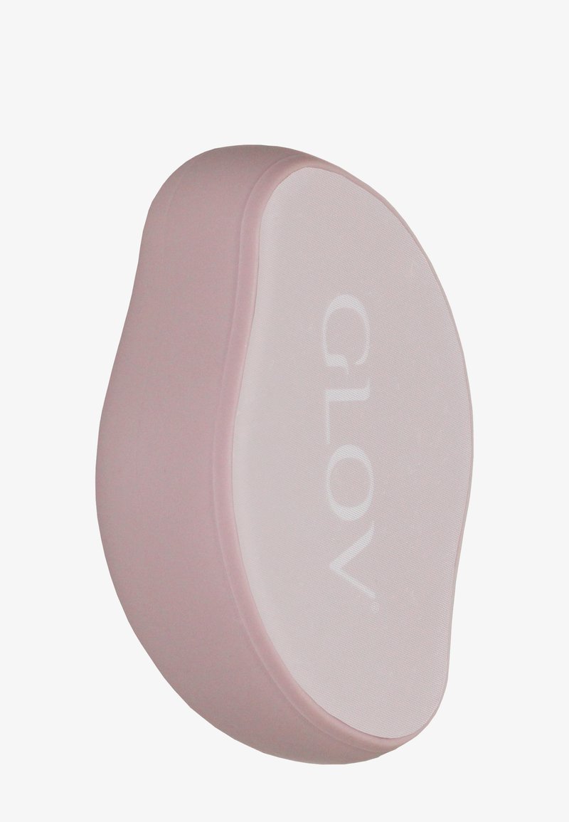 Tampon nettoyant en silicone rose avec une surface lisse blanche affichant "GLOV". Présente une forme ergonomique pour une prise en main facile.