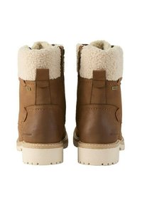 Bottines en cuir marron avec doublure en fausse fourrure crème, zips sur les côtés et semelle beige. Présente des accents cousus et des étiquettes de marque.