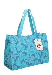 Sac fourre-tout turquoise présentant un motif de visages, avec des poignées doubles et une étiquette illustrée. Tissu texturé.