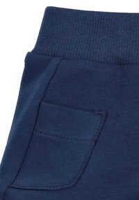 Marineblaue Sweatpants mit einem gerippten Bund und einer Seitentasche. Glatte Textur, lässiges Design mit einer Nahtdetail neben der Tasche.