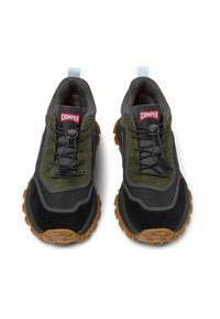 Sneaker nere e verdi oliva con tessuto texturizzato, suole in gomma e sistema di allacciatura a toggles. Presenta un'etichetta blu e un logo rosso.