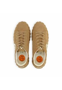 Light brown suede sneakers with round toe, thick rubber sole, lace-up design, gold eyelets, and orange logo detail on the insole.