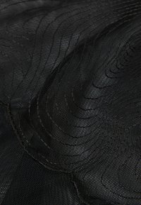 Black textured fabric featuring wave-like patterns and fine mesh detailing, with visible stitching along the edges. Soft and pliable material.
