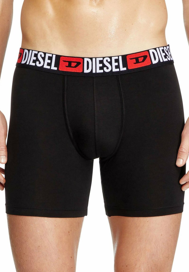 Czarne slipy sportowe wykonane z elastycznej tkaniny, z szerokim elastycznym paskiem w talii z logo "DIESEL" w czerwonym i białym kolorze.