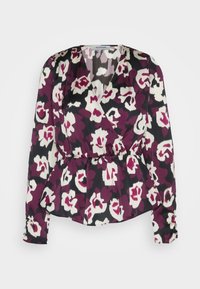 Blouse portefeuille à manches longues avec taille élastique, présentant un motif floral abstrait audacieux en violet, noir et blanc.