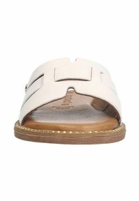 Light beige slide sandal with a soft leather upper, featuring a wide cut-out design, flat sole, and subtle stitching details.