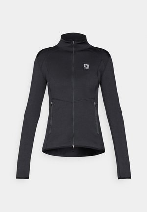 Schwarze Sportjacke mit hohem Kragen, durchgehendem Reißverschluss, zwei Reißverschlusstaschen und kontrastierenden Nähte. Glattes, dehnbares Material.