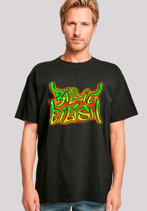 Black cotton t-shirt featuring vibrant green and orange graffiti-style text reading "Billie Eilish" across the chest. Relaxed fit, short sleeves.