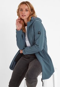 Softshell jacket in teal, featuring a hood, front zipper, and pockets. Ribbed cuffs and logo on the sleeve. Smooth texture.