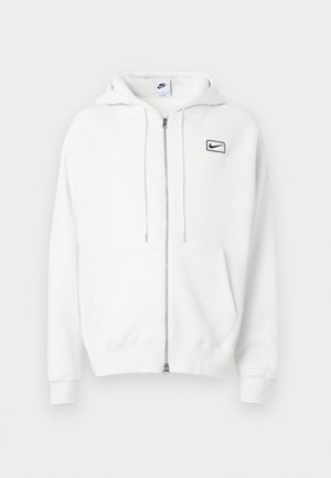 Hanorac alb cu fermoar, fabricat dintr-un amestec de bumbac, cu un buzunar frontal, glugă cu șnur și un mic logo Nike negru pe piept.