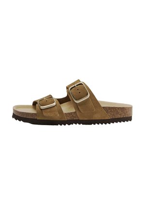 Brown suede sandal with double adjustable metal buckles, cork footbed, and black rubber sole viewed from the side.