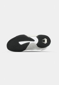 Sneaker with a textured black rubber sole featuring a white midsole and a sleek, streamlined design. Accented with a logo detail.