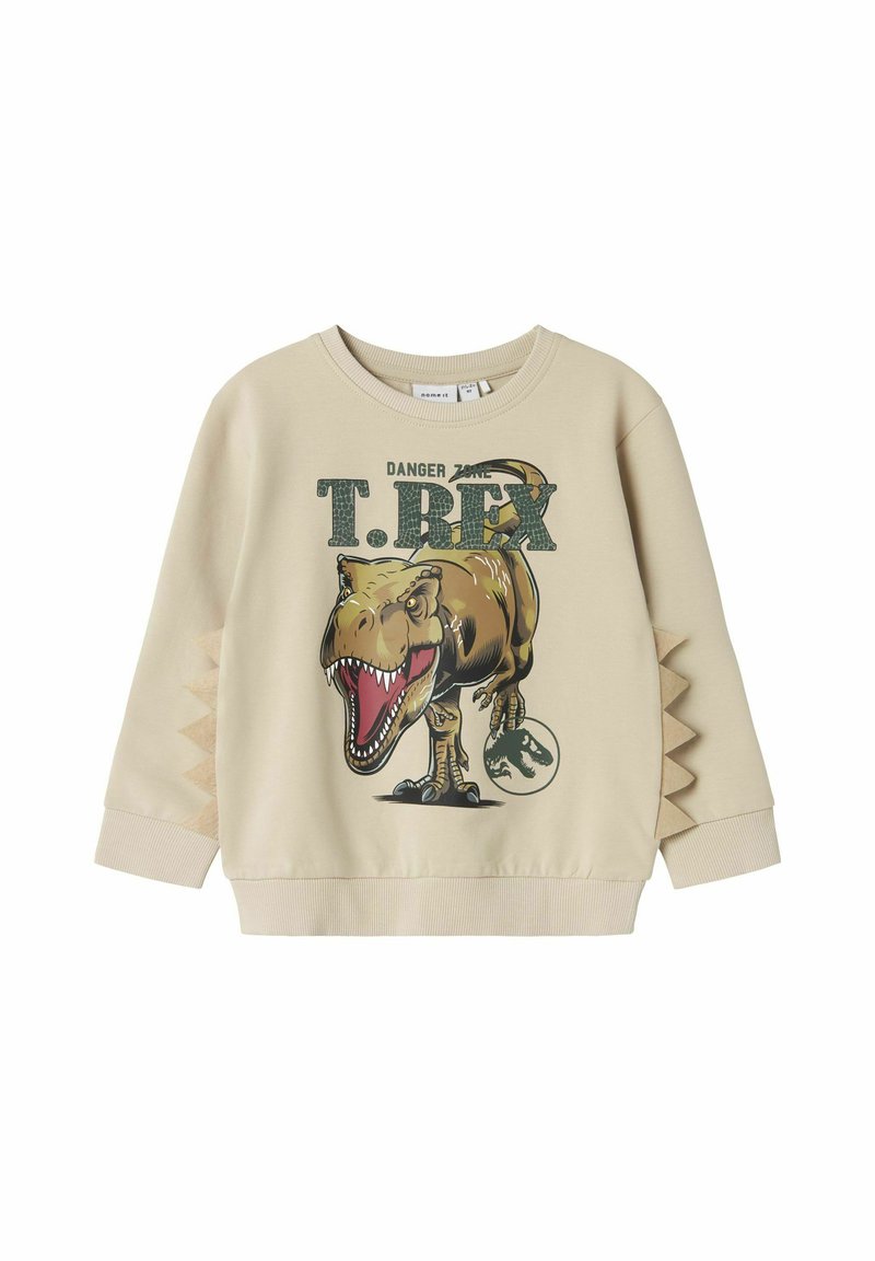 Sweatshirt beige con grafica di un T-Rex. Collo rotondo a coste, dettagli testurizzati sui lati che richiamano le spine dei dinosauri e stampa dettagliata.
