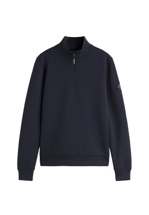 Sudadera de forro polar azul marino con cremallera hasta el pecho, cuello alto, puños y bajo acanalados, y una pequeña etiqueta de la marca en la manga izquierda.