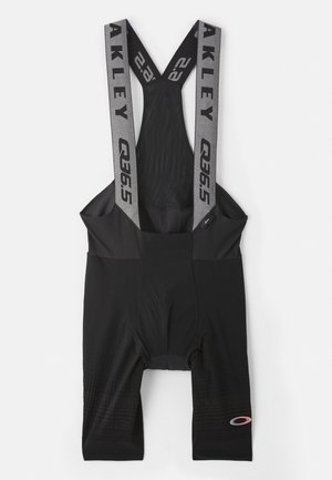 Pantalones cortos de ciclismo negros con tirantes elásticos que presentan el logo "AKLEY". Textura suave con asiento acolchado y patrones sutiles en la parte inferior de las piernas.
