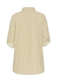 Bēša krāsas svītrains krekls ar apkakli, uzruļāmām piedurknēm un yoke detaļu aizmugurē. Izgatavots no viegla auduma ar vaļīgu piegriezumu.