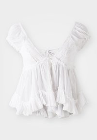 Hvit bluse med korte puffermer, blonderdetaljer, snøring i nakken og volangkant. Laget av lett, teksturert stoff.