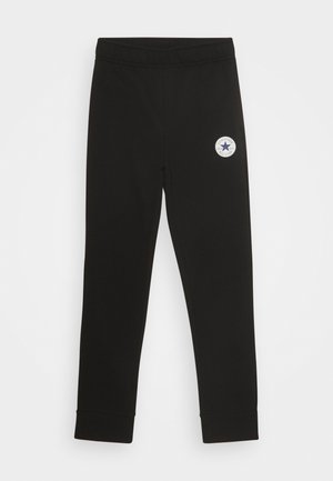 Sorte slim-fit sweatpants med elastisk talje og hvidt rundt Converse All Star-logo på den øverste lår.