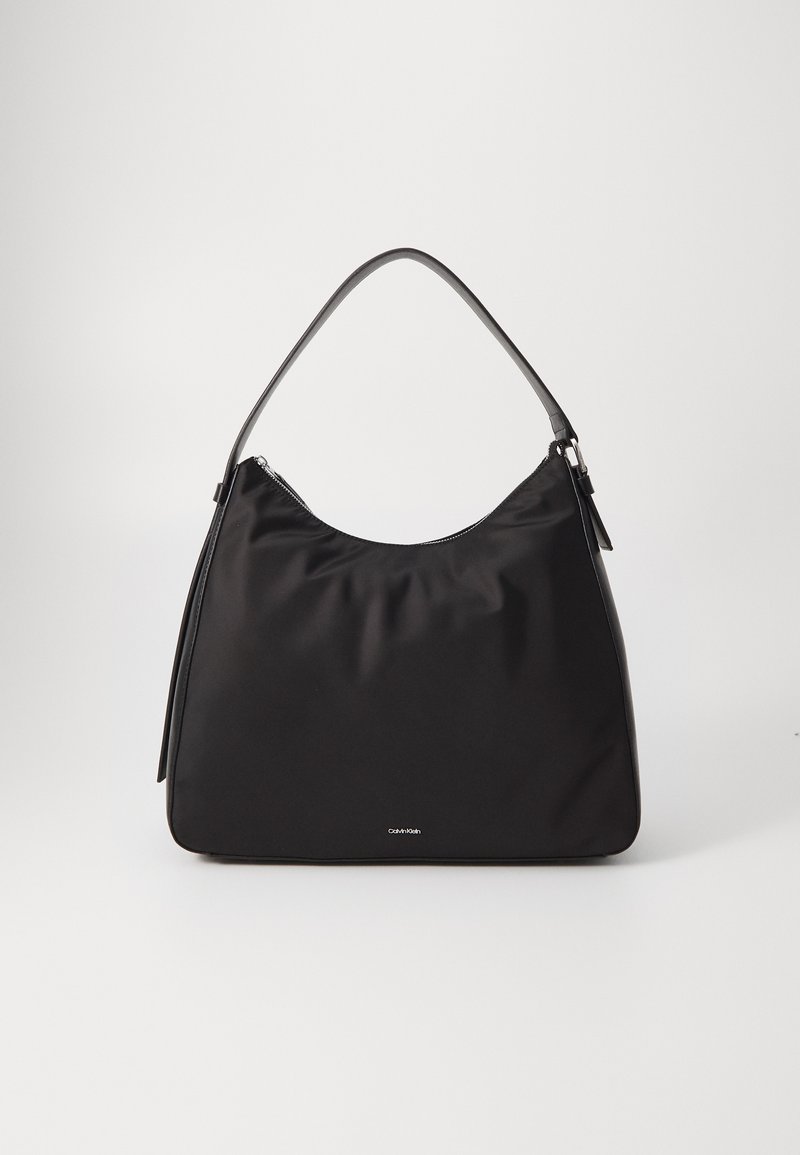 Black nylon shoulder bag with a smooth texture, curved top, metal zipper closure, and a single flat handle. Features a subtle logo on the front.