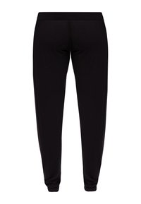 Czarne, dopasowane dresy z miękkiej bawełny, z elastycznym pasem i zwężanymi nogawkami. Brak widocznych wzorów lub detali metalowych.