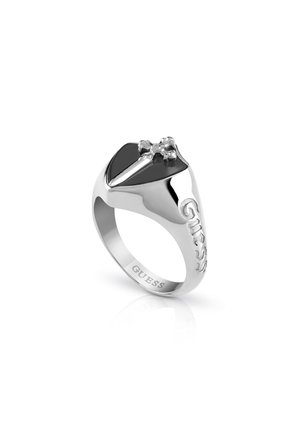 Silver-toned ring features a black center stone with a cross accent, embossed "GUESS" logo, and polished finish. Rounded, sleek design.