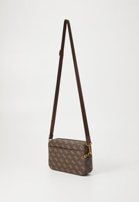 Brown leather shoulder bag featuring a textured surface, gold hardware, and a repeating logo pattern. Adjustable strap for length customization.