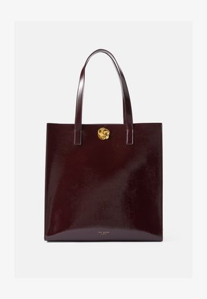 Burgundy patent leather tote bag with two handles, features a gold flower accent on the front, smooth texture and structured shape.