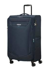 Valigia rigida blu navy con manico allungabile, ruote girevoli, scomparti con cerniera e un logo frontalmente.