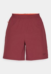 Burgundské športové šortky s elastickým pásom, oranžovým vnútorným podšívaním a bočnými vreckami. Majú jemné označenie na nohe.