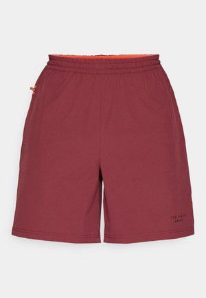 Burgundowe szorty sportowe z elastycznym paskiem w talii, pomarańczową podszewką i detalami w postaci bocznych kieszeni. Posiadają subtelne logo na nogawce.