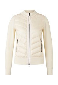 Light cream jacket with a quilted front and ribbed sleeves. Features zippered pockets and a high collar design with a two-way zipper closure.