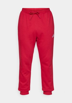Κόκκινο αθλητικό παντελόνι από απαλή ύφανση, με ελαστική μέση και κορδόνι, καθώς και τελείωμα με μανσέτα. Μικρό λογότυπο στον μηρό.