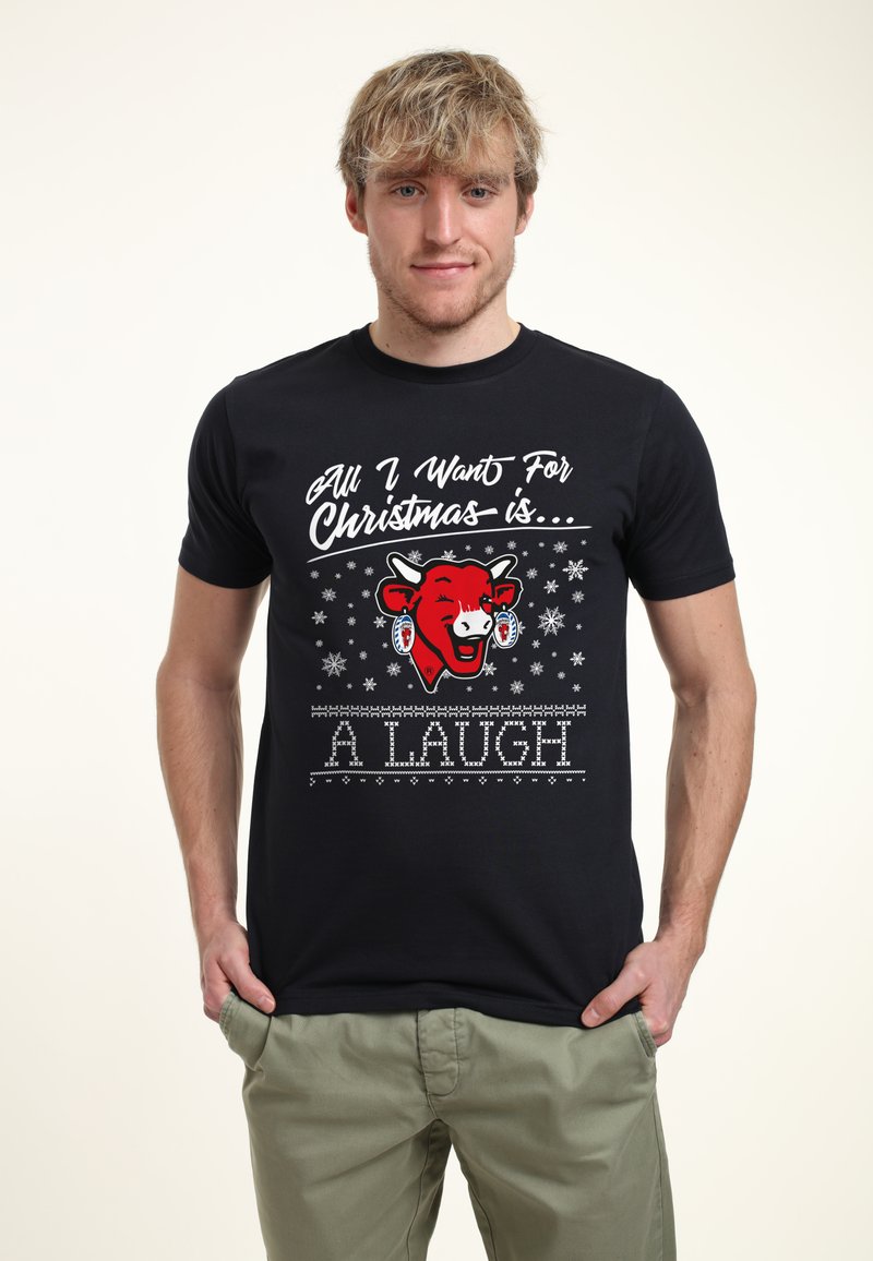 Svart bomullströja med ett rött tecknat koansikte, vit text, snöflingor och dekorativa mönster med frasen "All I Want For Christmas is... A LAUGH."