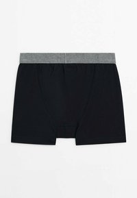 Black cotton boxer shorts with a grey elastic waistband, featuring a mid-length cut and a smooth, stretchable fabric texture.