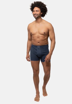 Boxer shorts blu navy con motivo testurizzato, vita elastica e lunghezza a metà coscia. Realizzati in tessuto morbido per il massimo comfort.