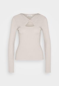 Haut à manches longues côtelé beige clair avec un col croisé et une ouverture en forme de trou de serrure. Silhouette ajustée et texture douce.