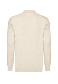 Beige knit sweater with a round neckline and long sleeves. Features a textured fabric and ribbed hem and cuffs.
