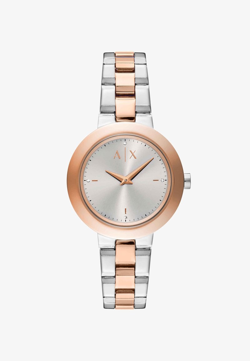 Zilveren en roségouden polshorloge met minimalistische wijzerplaat, roségouden lunette en metalen schakelarmband die 10:09 uur aangeeft.