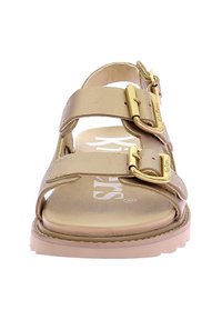 Gold leather sandals with two adjustable straps, gold buckles, and a contoured footbed. Flat sole with textured detailing for grip.