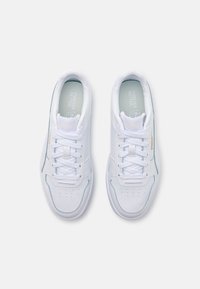 White athletic shoes with a smooth leather upper, featuring padded tongue, perforations near the toes, and subtle blue accents on the sides.