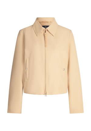 Beige cropped jack met een puntige kraag, een rits aan de voorkant en twee klepzakken. Heeft een gladde, getextureerde stof en subtiele stikdetails.