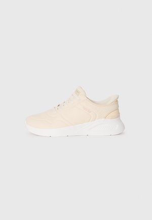 Beige athletic shoes with a textured upper, lace-up closure, and a white rubber sole. Features perforations for breathability and a cushioned heel.