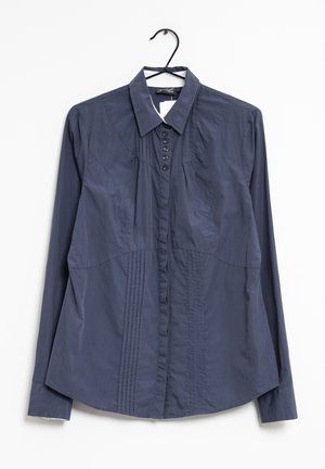Navy blue long-sleeve shirt featuring a pointed collar, button placket with six dark buttons, and vertical pleats on the front.
