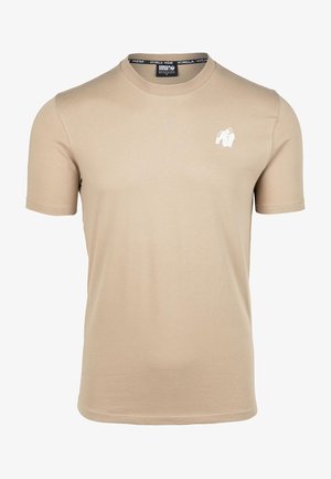 T-shirt beige a maniche corte realizzato in morbido cotone, con un piccolo logo di gorilla bianco sul lato sinistro del petto. Design classico a girocollo.